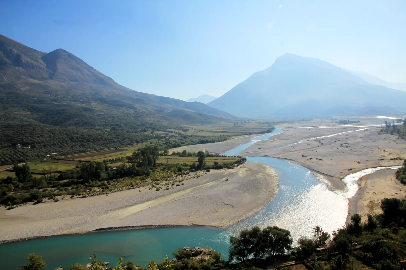 A braided river winding through a wide mountain valley