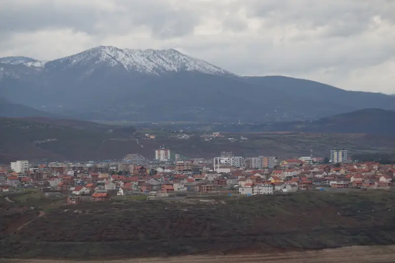 The town of Kukës in north-east Albania below a snow-capped mountain